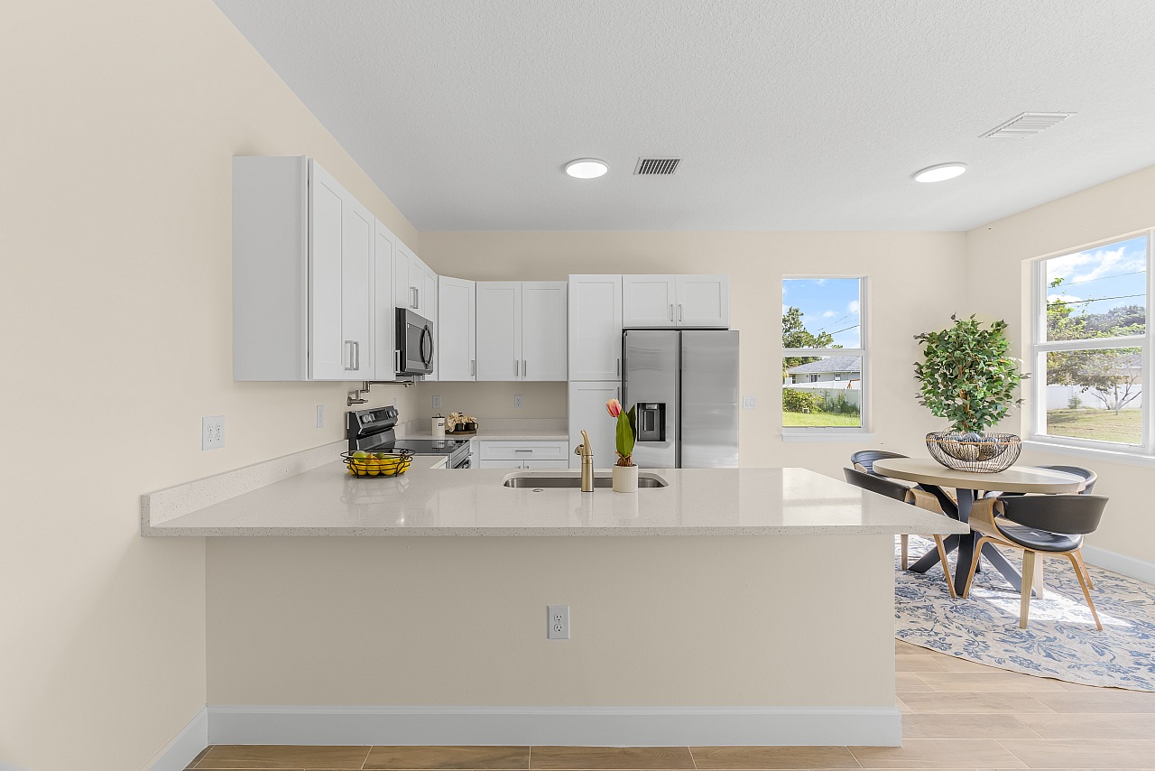 Representative white kitchen and breakfast area in the rent-to-own model