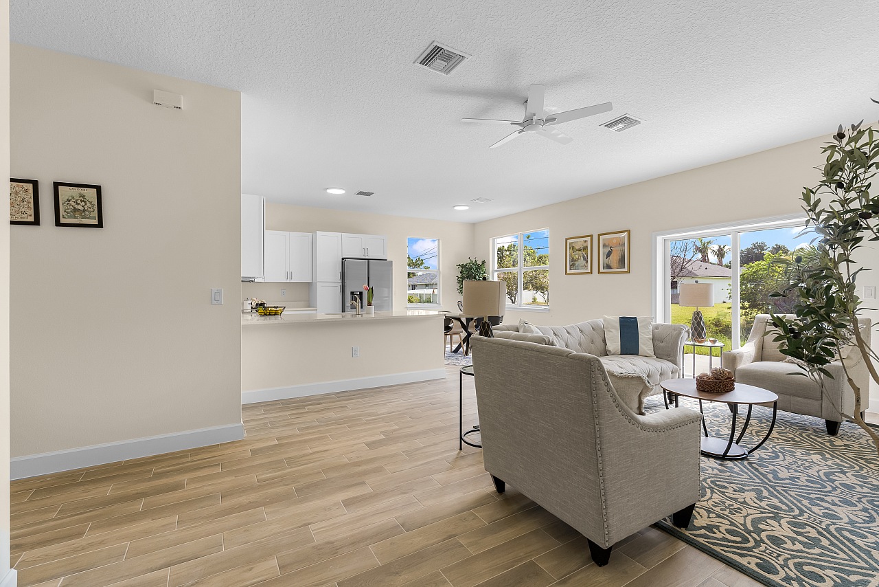 Open-concept living room and kitchen in an Osuna Homes model